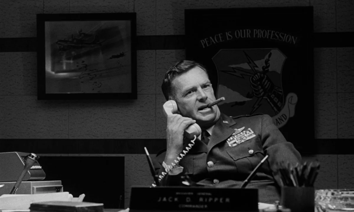 Dr. Strangelove or: How I Learned to Stop Worrying and Love the Bomb (1964) movie still: medium — A military office interior featuring a framed wall…