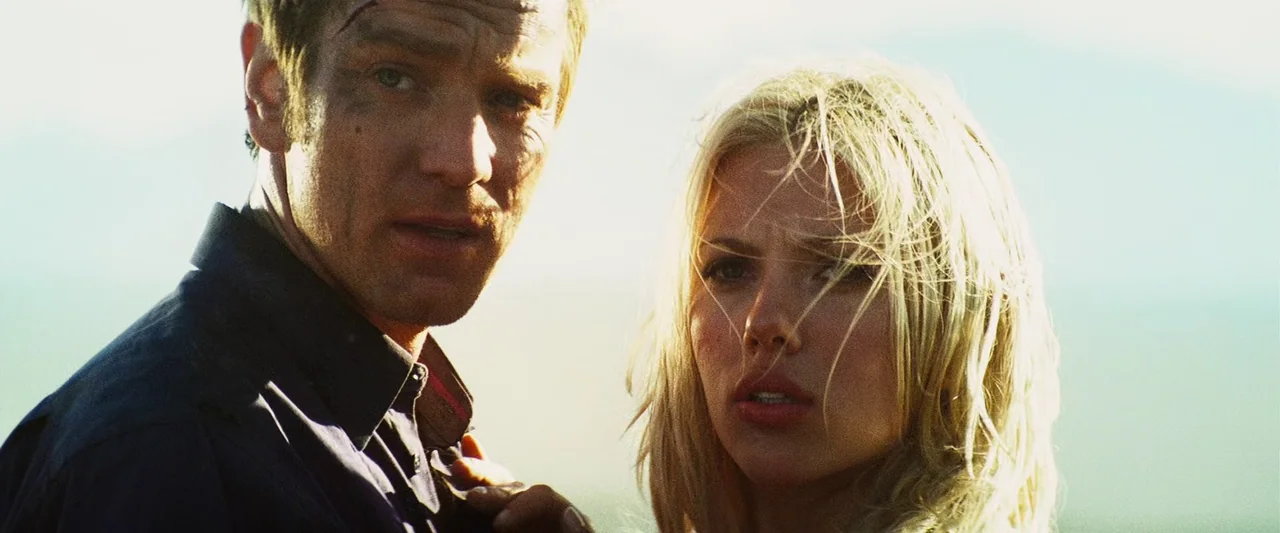 The Island (2005) movie still: medium — A man and a woman stand close together in an open outdoor environment. Both figures look toward the camera…