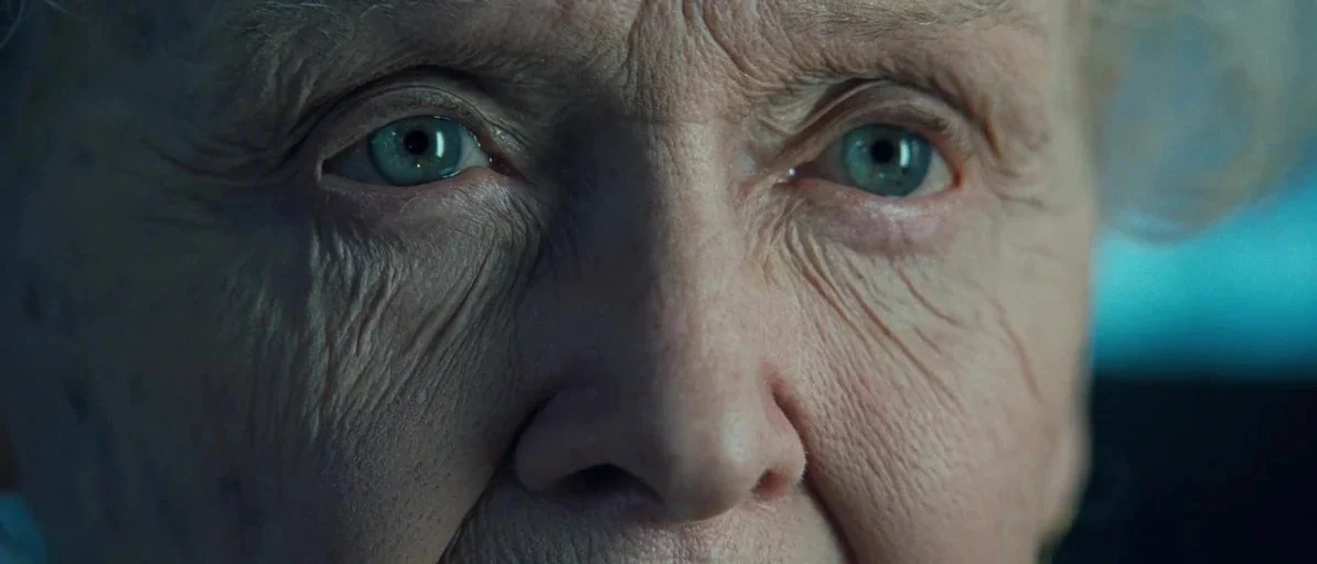 Titanic (1997) movie still: closeup — An extreme close-up of an elderly woman's face fills the frame completely. She stares directly into the camera…