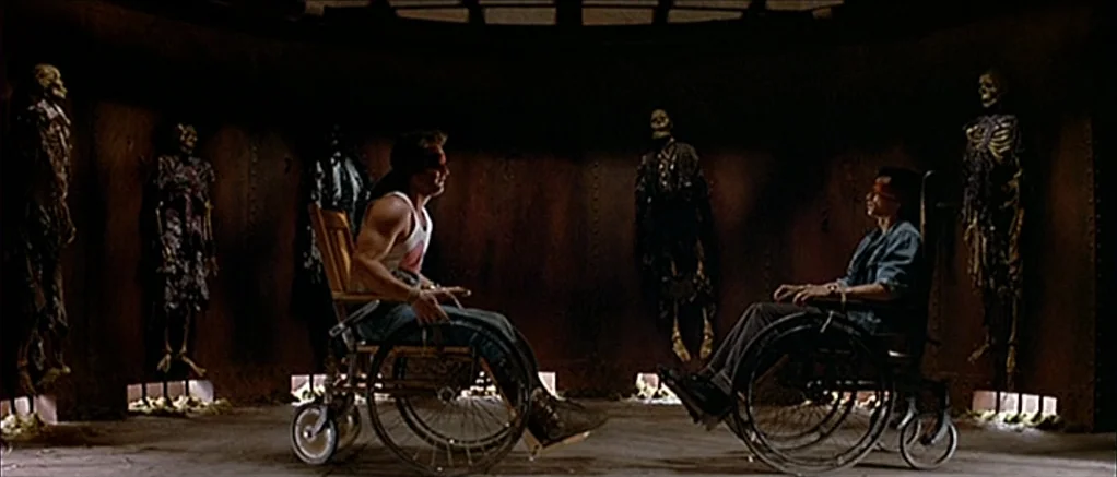 Big Trouble in Little China (1986) movie still: wide — A circular chamber features metallic walls lined with upright human skeletons mounted as…