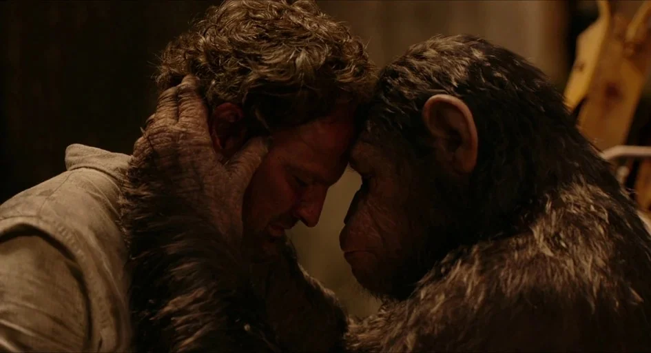 Planet of the Apes (2001) movie still: closeup — A dimly lit room provides a background for two distinct subjects facing each other. A man with…