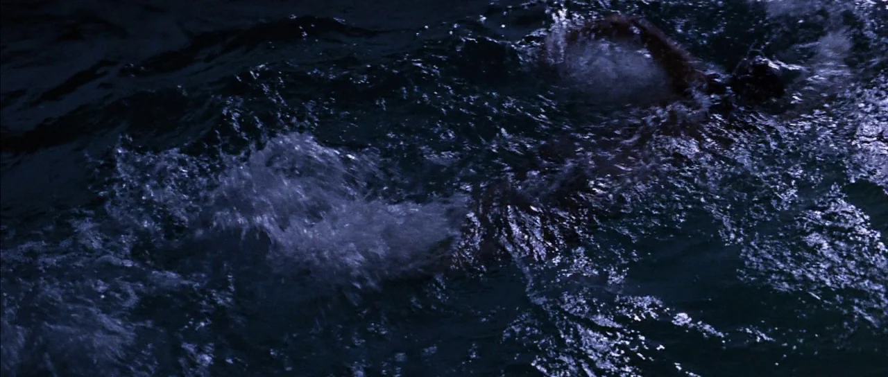 You Only Live Twice (1967) movie still: wide — A dark expanse of turbulent water fills the frame during the night. Ripples and splashes indicate…