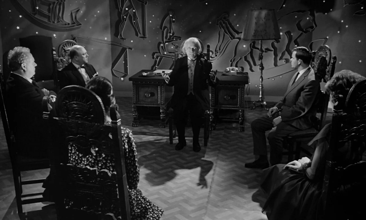 The 1,000 Eyes of Dr. Mabuse (1960) movie still: wide — A dimly lit room features walls decorated with star patterns and mythological silhouettes.…