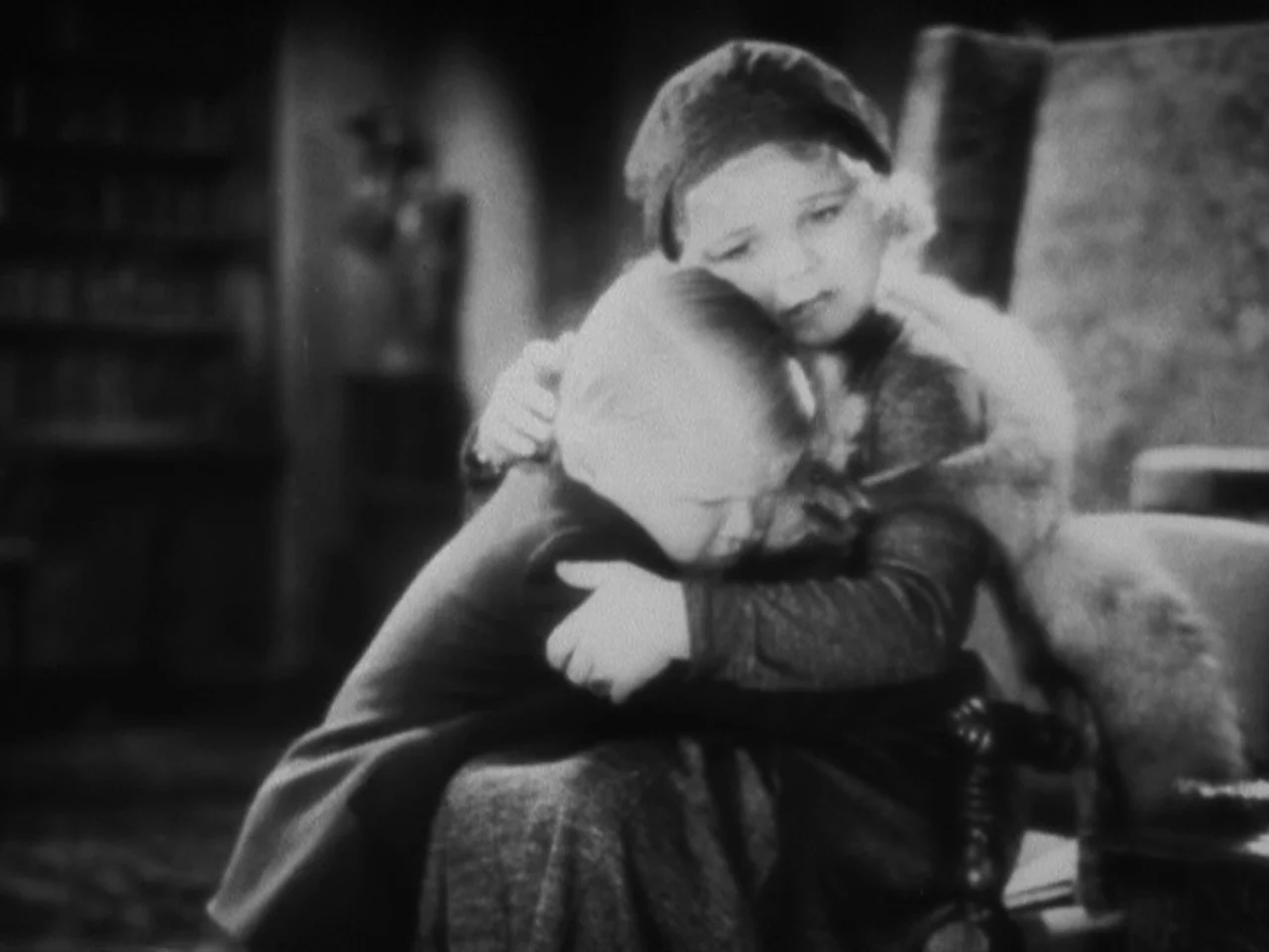 Freaks (1932) movie still: An intimate, black-and-white portrait of a woman tenderly embracing a small child. The soft, vintage lighting and the…