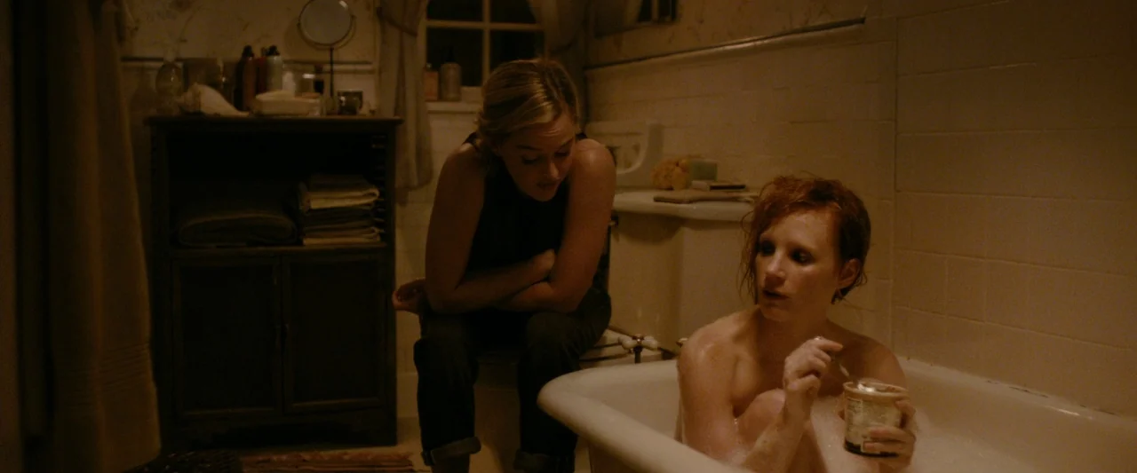 The Disappearance of Eleanor Rigby: Her (2014) movie still: medium — A dimly lit bathroom features white tile walls and a wooden shelving unit. One…