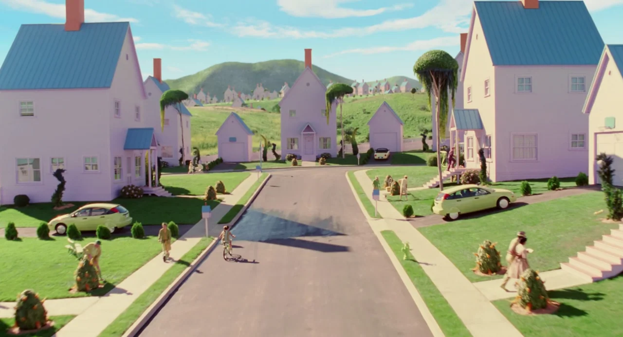 The Cat In The Hat (2003) movie still: establishing — A stylized suburban neighborhood features pastel lavender houses and manicured lawns under a…