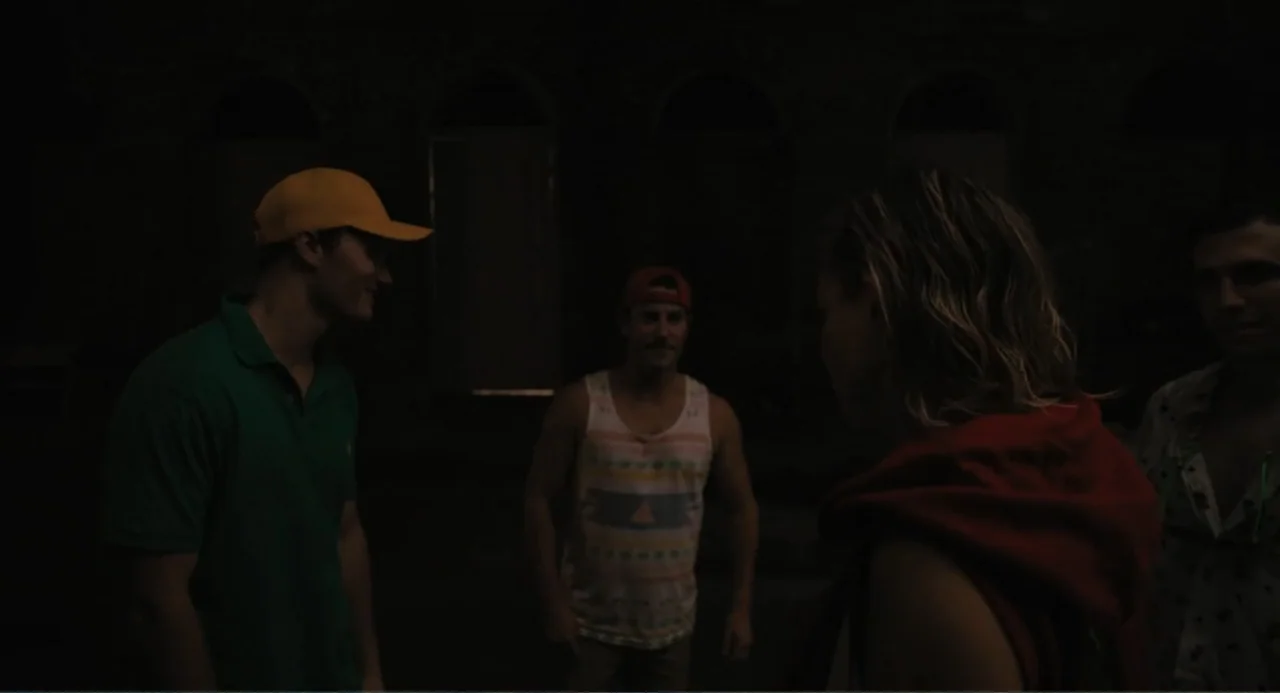 Mona Lisa and the Blood Moon (2022) movie still: medium — A dark outdoor space at night with four people gathered together in the frame. The…