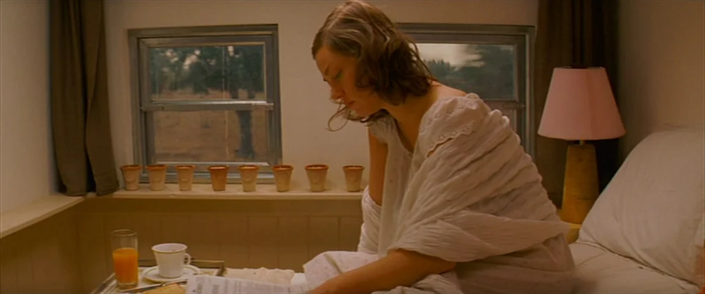 The Darjeeling Limited (2007) movie still: medium — A small train compartment cabin features wood paneling and windows showing a passing landscape.…