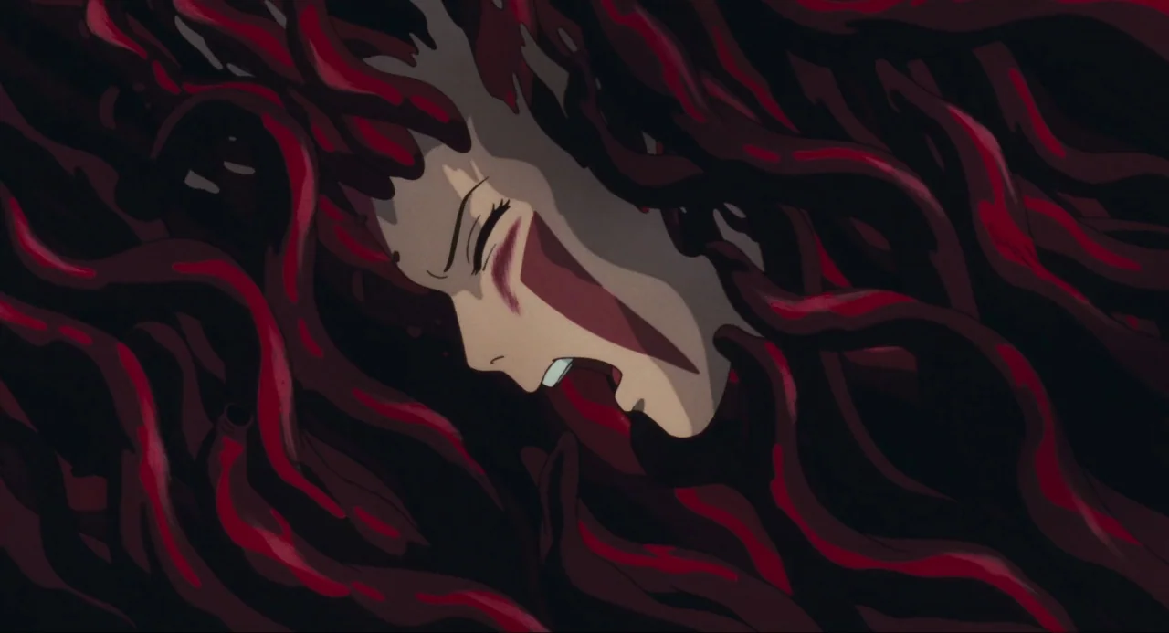 Princess Mononoke (1997) movie still: closeup — A human head is surrounded by thick, dark red, vine-like organic tendrils. The character has eyes…