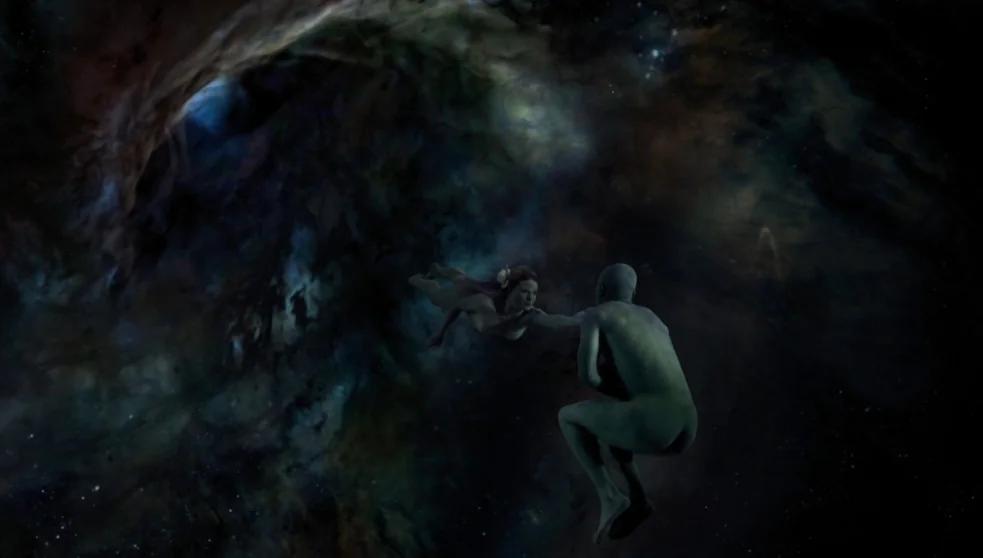 The Zero Theorem (2013) movie still: wide — A vast nebula filled with swirling dark dust and starlight spans the entire frame. A woman and a blue…