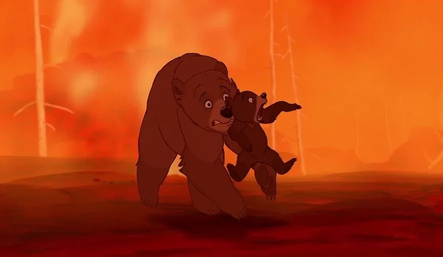 Brother Bear (2003) movie still: fullbody — A burning forest is filled with thick orange smoke and scorched tree trunks. An adult brown bear trots…