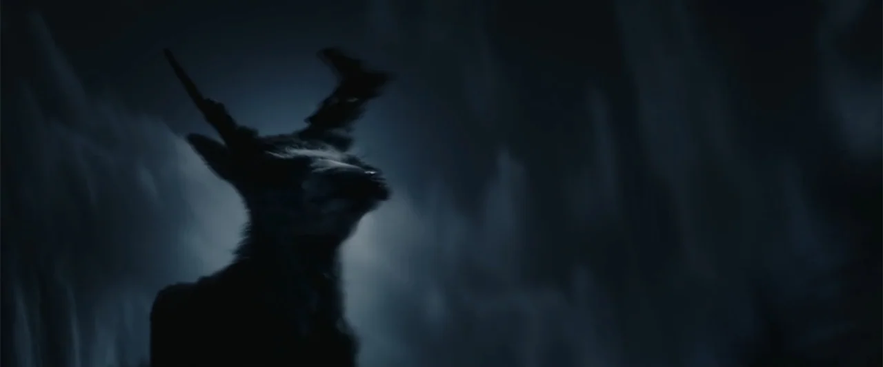 Freud's Last Session (2023) movie still: closeup — A dark night scene shows a deer silhouette in a cold, snowy environment. The creature stands in…
