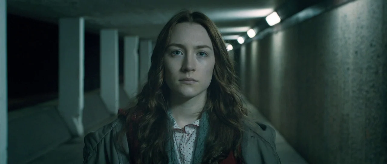 Byzantium (2012) movie still: medium — A concrete pedestrian tunnel features repetitive white support pillars and overhead fluorescent lighting. A…
