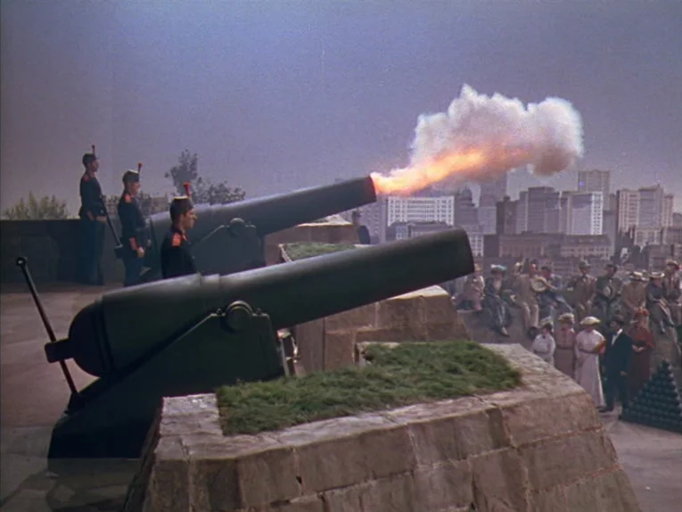 Annie Get Your Gun (1950) movie still: wide — A stone fortification features cannons aimed towards a distant cityscape under a hazy sky. Soldiers in…