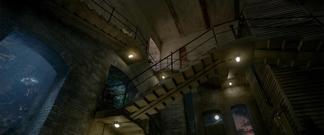 Fantastic Beasts: The Crimes of Grindelwald (2018) movie still: establishing — An interior industrial stairwell features brick walls, iron railings,…