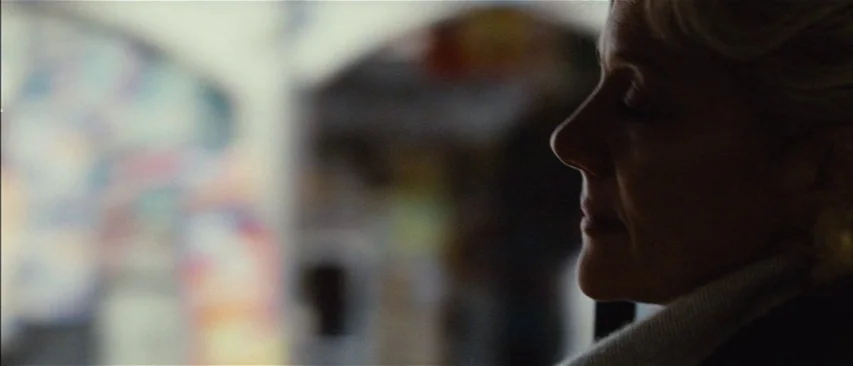The Headless Woman (2008) movie still: closeup — An interior space with blurry architectural arches visible in the background out of focus. A woman…