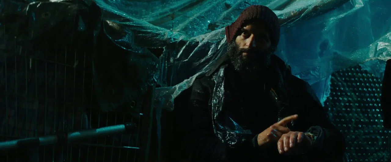 John Wick: Chapter 3 – Parabellum (2019) movie still: medium — A makeshift shelter constructed from blue plastic sheeting and metal grating at…
