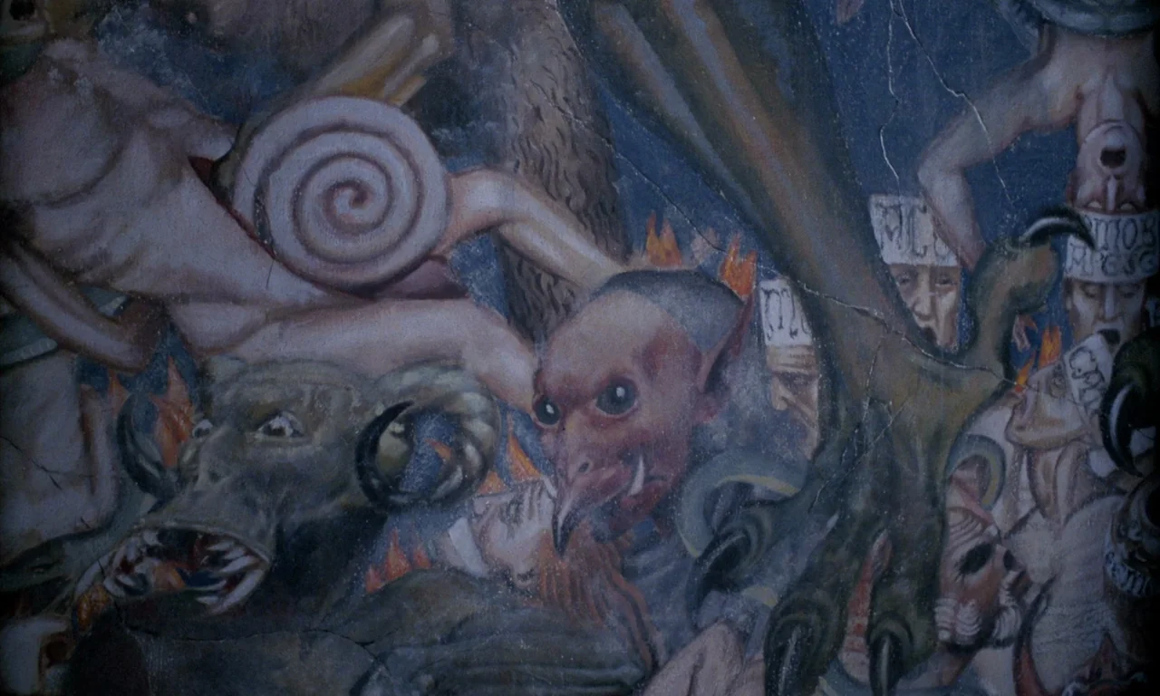 The Church (1989) movie still: closeup — A mural painting depicts various demonic entities and humans in an intricate, crowded composition. The…