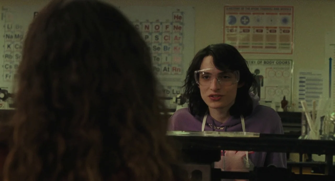 When You Finish Saving The World (2022) movie still: medium — A high school science laboratory features educational posters on the walls. A male…