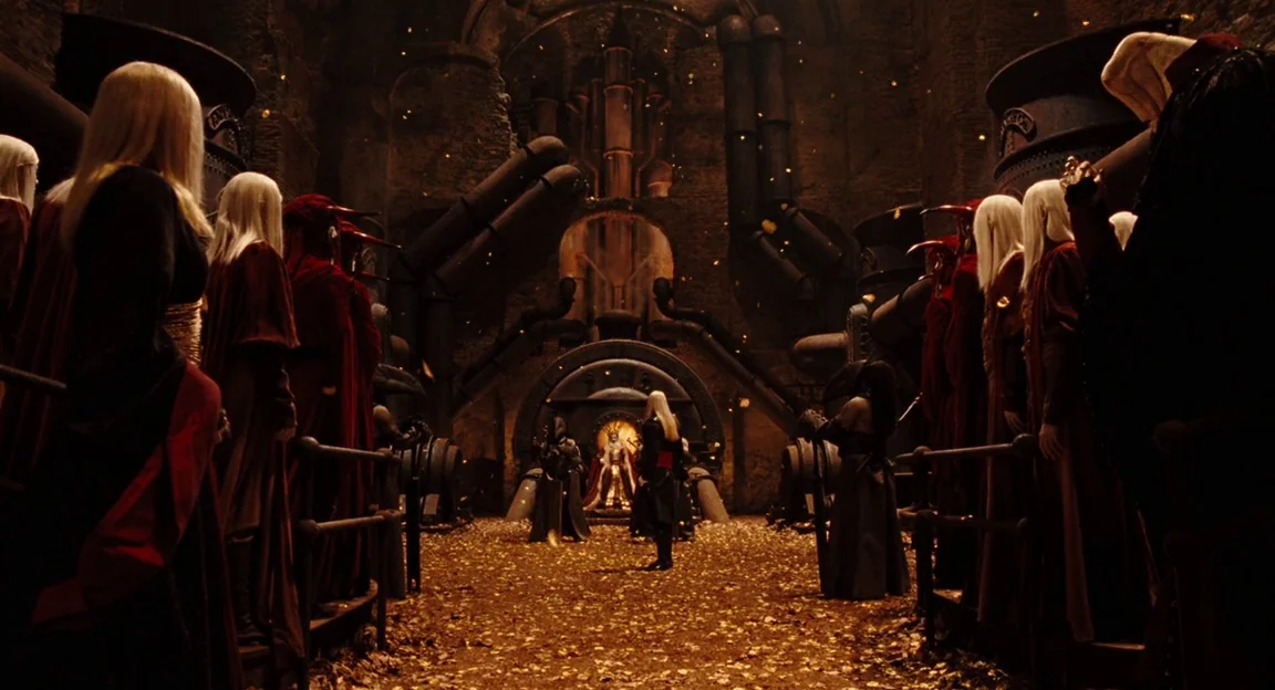 Hellboy II: The Golden Army (2008) movie still: wide — A cavernous stone hall features massive dark pipes and a central throne made of metal. A…