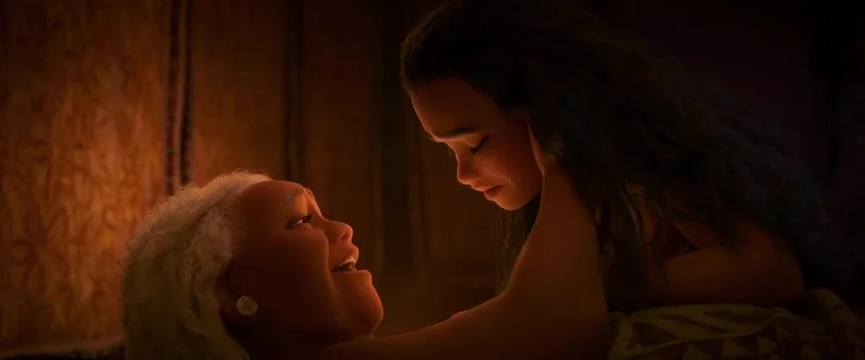 Moana (2016) movie still: medium — A dimly lit room with walls featuring tribal patterns and warm golden illumination. A young woman reclines toward…