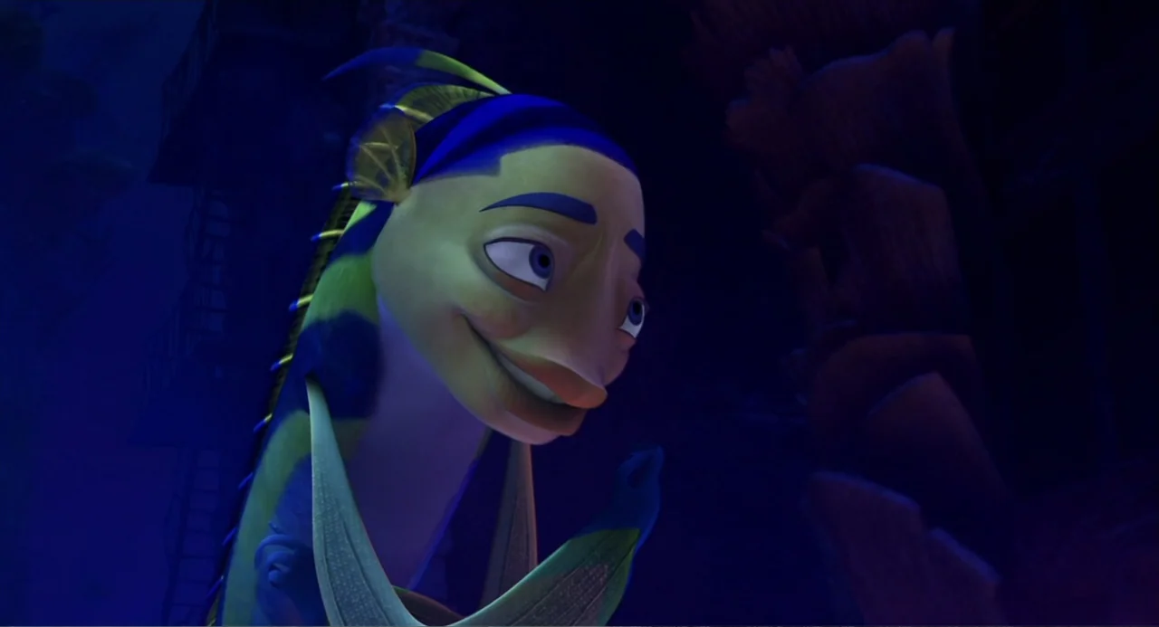 Shark Tale (2004) movie still: closeup — An underwater scene features a stylized anthropomorphic fish in a dark environment. The fish turns its head…
