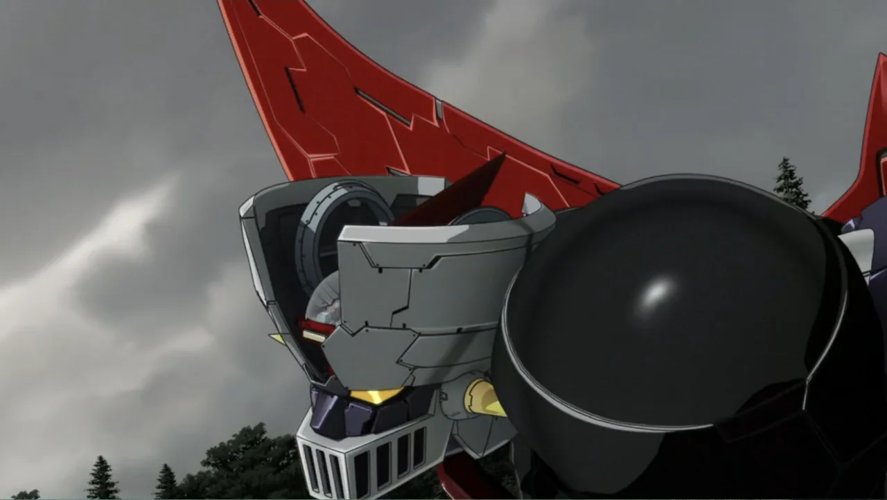 Mazinger Z: Infinity (2017) movie still: closeup — A close up view of a massive mechanical robot head against a dark stormy sky. The robot is…