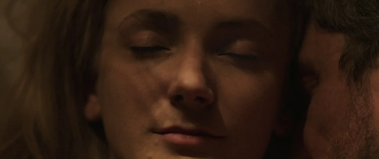 On Body and Soul (2017) movie still: An extremely intimate, soft-lit close-up of two individuals resting their heads together in total silence. The…
