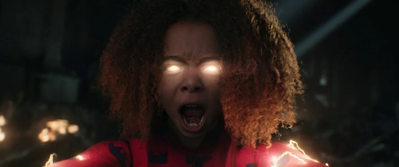Thor: Love and Thunder (2022) movie still: closeup — A dark, dimly lit environment surrounds the subject. A young girl with glowing eyes and hands…