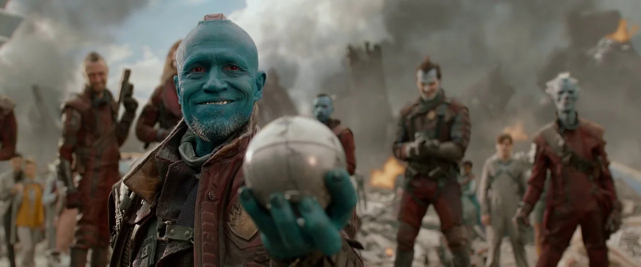 Guardians of the Galaxy (2014) movie still: medium — A war-torn battlefield filled with smoke and debris from recent heavy combat. A blue-skinned…