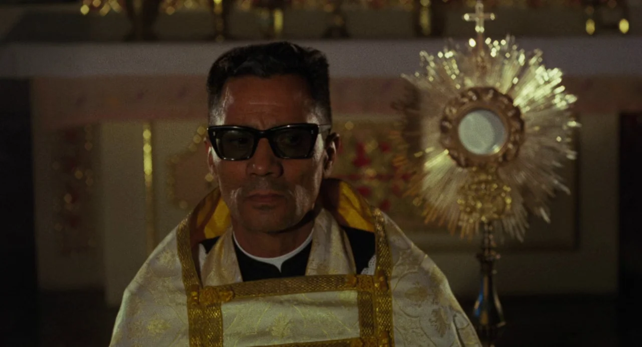 Canoa: A Shameful Memory (1976) movie still: medium — An interior shot showing a man in religious attire standing before a church altar. A large…