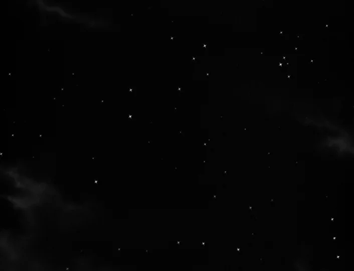 The White Sheik (1952) movie still: establishing — A dense cluster of stars populates a pitch-black expanse of the night sky. Faint clouds of…