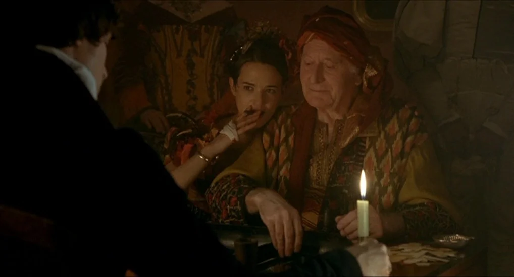 The Last Mistress (2007) movie still: medium — A dimly lit, claustrophobic space decorated with rich, worn textiles and antique patterned fabrics. A…