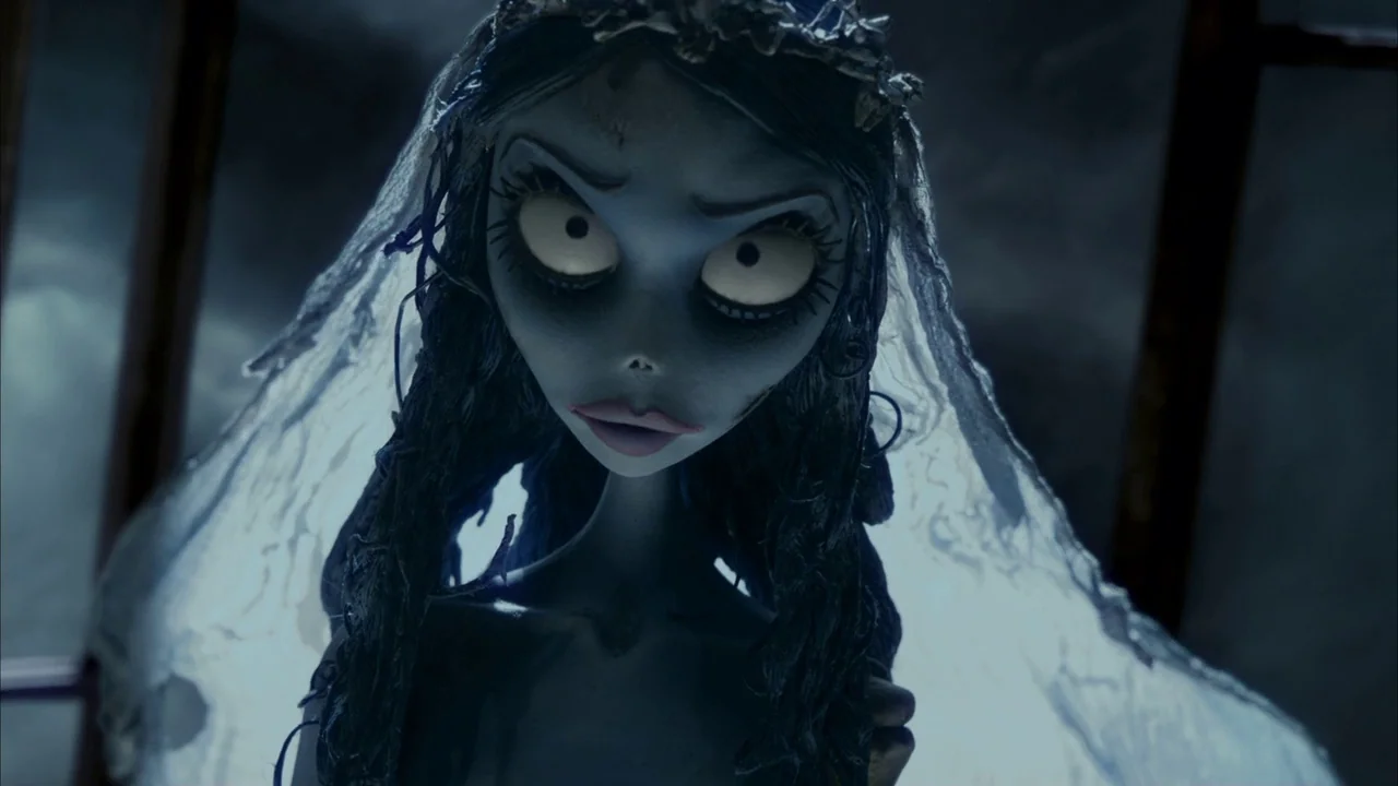 The Corpse Bride (2005) movie still: closeup — A pale, skeletal figure stands within a misty, dark, and moonlit outdoor environment. The character…