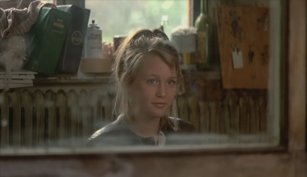 A Swedish Love Story (1970) movie still: closeup — A cluttered work area features a metal radiator, stacked folders, and various supplies. A teenage…