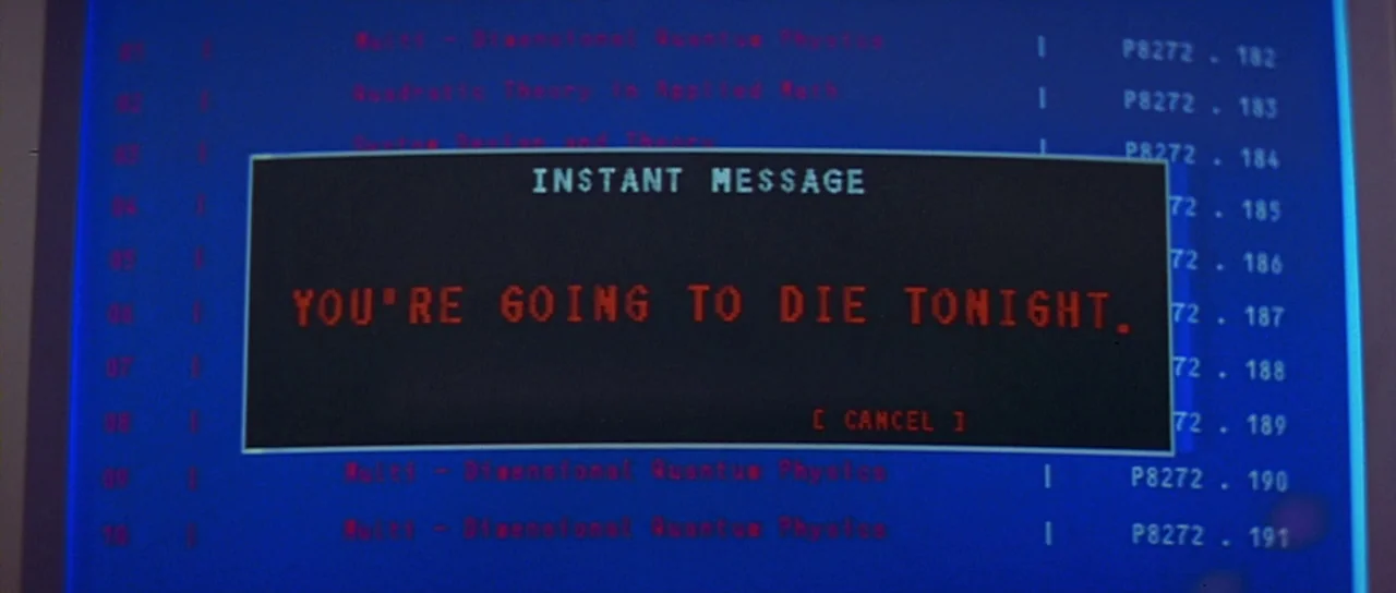 Scream 2 (1997) movie still: closeup — A dark computer screen displays a list of file entries on a bright blue background. A central rectangular…