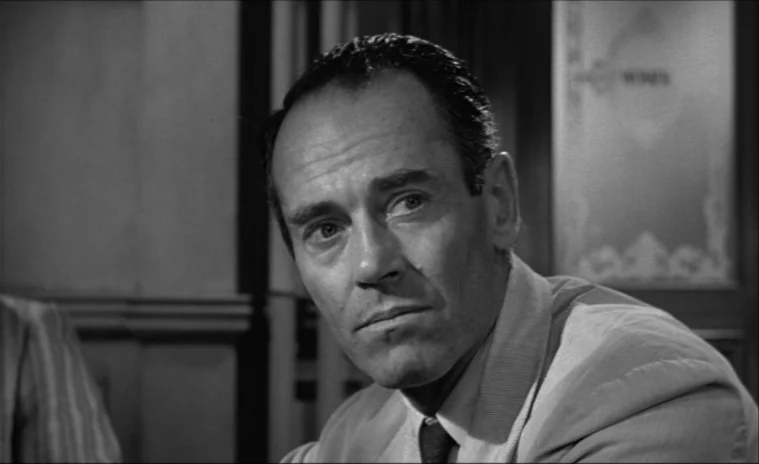 12 Angry Men (1957) movie still: closeup — A jury room environment with wooden architectural paneling visible in the blurred background. A…