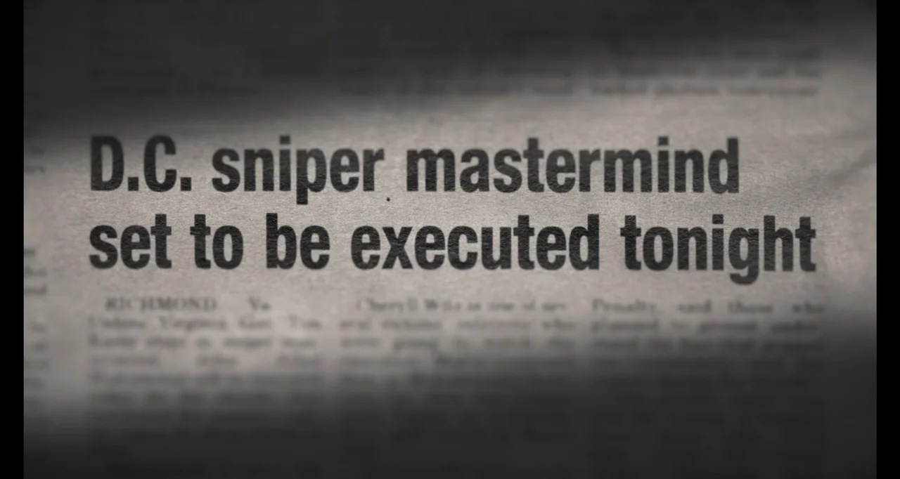 Hunted by My Husband: The Untold Story of the DC Sniper (2025) movie still: closeup — A close-up view of a newspaper headline printed on off-white…
