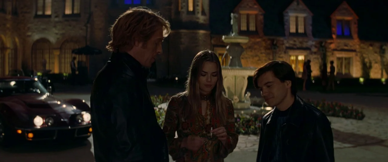 Once Upon a Time… In Hollywood (2019) movie still: medium — A stone mansion exterior at night features a central decorative fountain and paved…