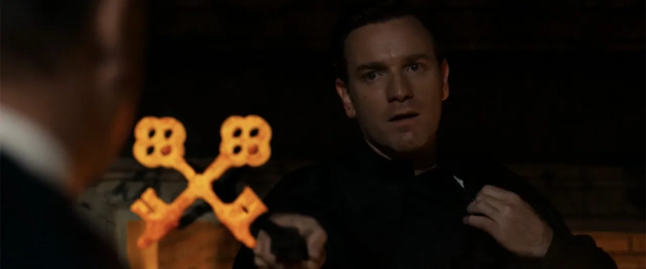 Angels & Demons (2009) movie still: medium — A dark interior space features a man holding glowing hot metal objects.
