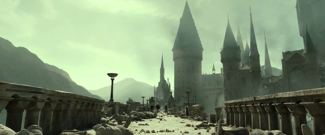 Harry Potter & The Deathly Hallows Part 2 (2011) movie still: establishing — A long stone bridge cluttered with rubble connects to a massive…