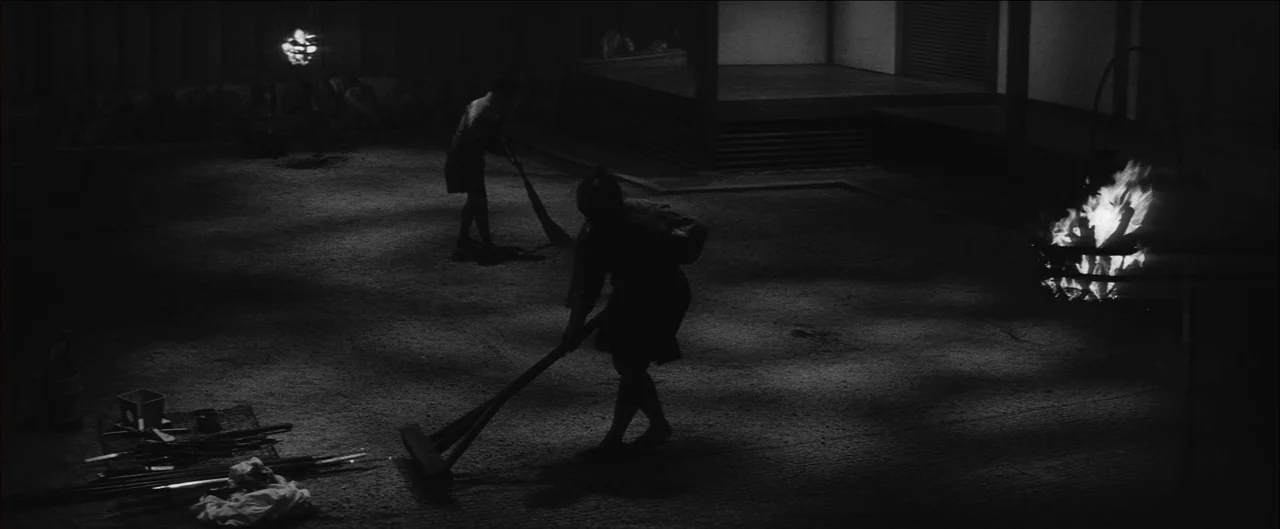 Harakiri (1962) movie still: wide — A gravel-covered courtyard at night features a dark traditional building in the background. Two figures in…