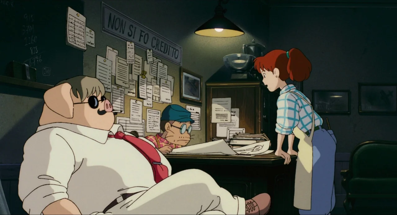 Porco Rosso (1992) movie still: medium — A cluttered workshop interior features a dark wall covered with papers and notices. A woman stands by a…