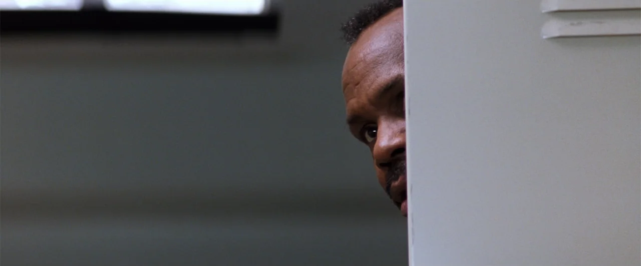 Lethal Weapon 4 (1998) movie still: closeup — A locker room interior featuring a grey metal door or locker covering most of the frame. A middle-aged…