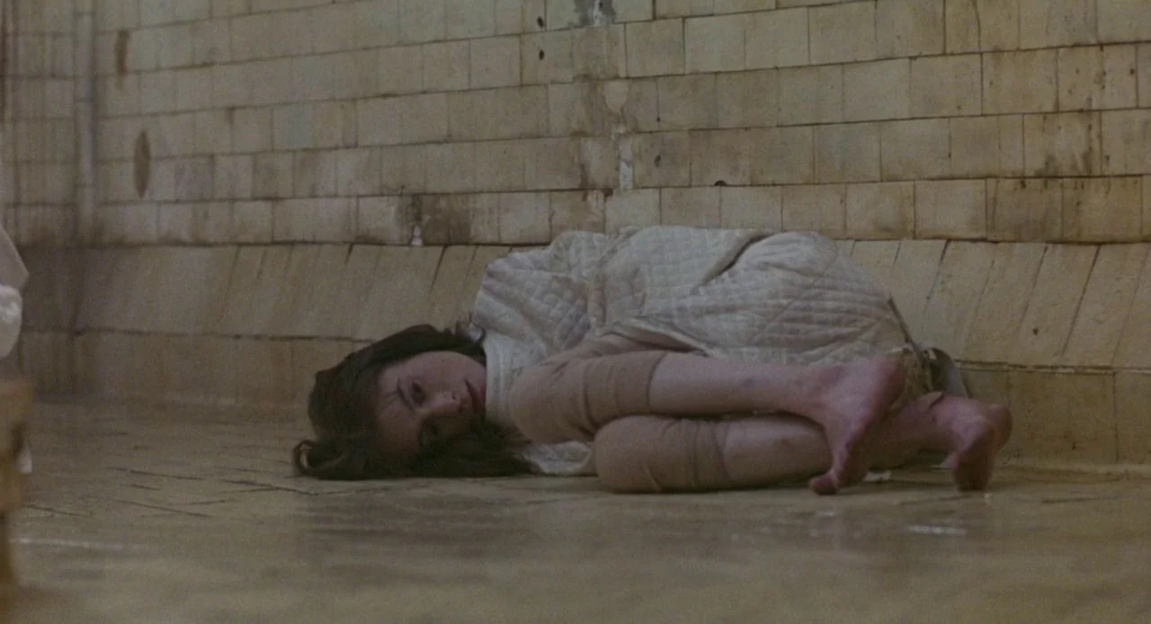 Jacob’s Ladder (1990) movie still: medium — An interior space features tiled walls and floor, suggesting an institutional or medical setting. A…