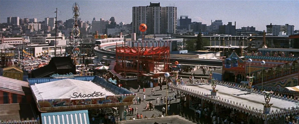 It Happened At The World’s Fair (1963) movie still: establishing — A sprawling amusement park features various carnival rides, a monorail, and a…