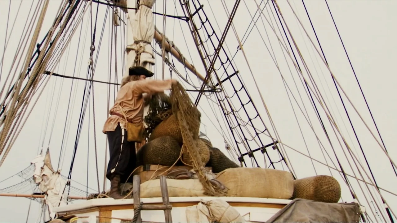 Epic Movie (2007) movie still: fullbody — The deck of a wooden sailing ship is cluttered with large burlap-covered bundles. A man in a period tunic…