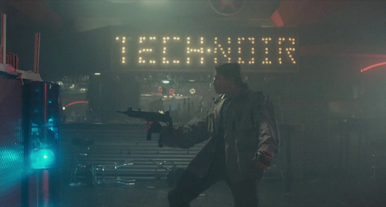 The Terminator (1984) movie still: fullbody — A smoky nightclub interior features a bright 'TECH-NOIR' neon sign above the bar area. A muscular man…