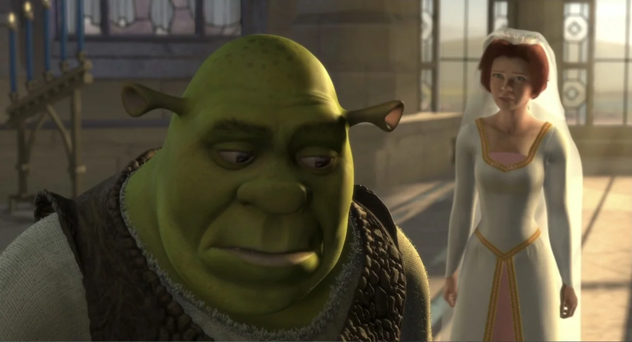 Shrek (2001) movie still: medium — A stone interior with large windows and a candle stand in the background. An ogre stands in the foreground while…
