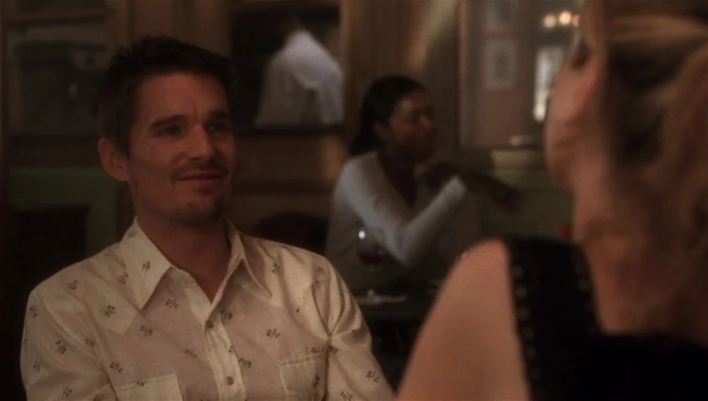 Before Sunset (2004) movie still: medium — A dimly lit restaurant interior provides the setting for a private conversation. The male subject sits at…
